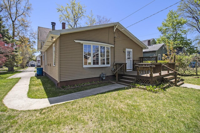 805 E Filer St, Ludington, MI 49431 - view of front of home with a front lawn and a deck