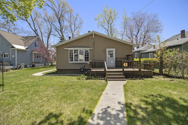 805 E Filer St, Ludington, MI 49431 - bungalow-style home featuring a wooden deck and a front lawn
