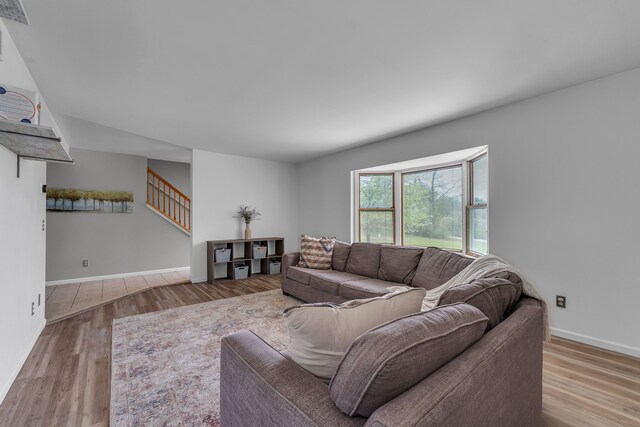 17035 Weber Rd, Holly, MI 48442 - living area featuring wood finished floors, stairway, and baseboards