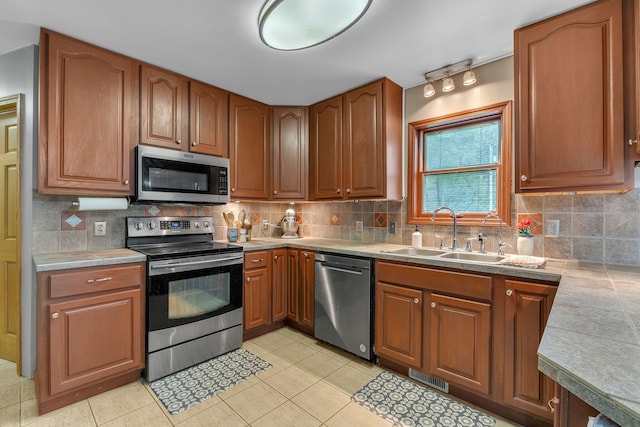 17035 Weber Rd, Holly, MI 48442 - kitchen featuring appliances with stainless steel finishes, a sink, light countertops, and tasteful backsplash