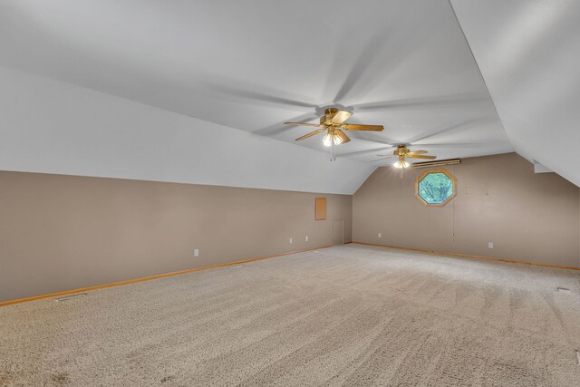 17035 Weber Rd, Holly, MI 48442 - additional living space with a ceiling fan, vaulted ceiling, baseboards, and light colored carpet