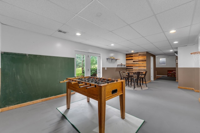 17035 Weber Rd, Holly, MI 48442 - playroom featuring concrete flooring, baseboards, recessed lighting, and a drop ceiling