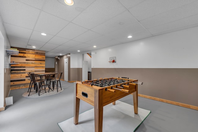 17035 Weber Rd, Holly, MI 48442 - playroom featuring finished concrete flooring, a paneled ceiling, baseboards, and recessed lighting