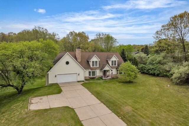 17035 Weber Rd, Holly, MI 48442 - view of front of house with concrete driveway, an attached garage, a front yard, and a chimney