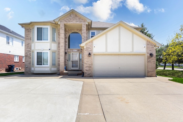 view of front of home featuring brick siding, concrete driveway, and a garage