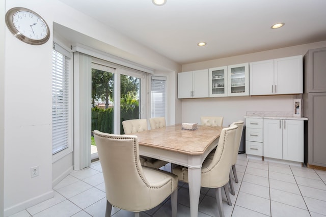 dining area featuring recessed lighting, light tile patterned floors, and baseboards