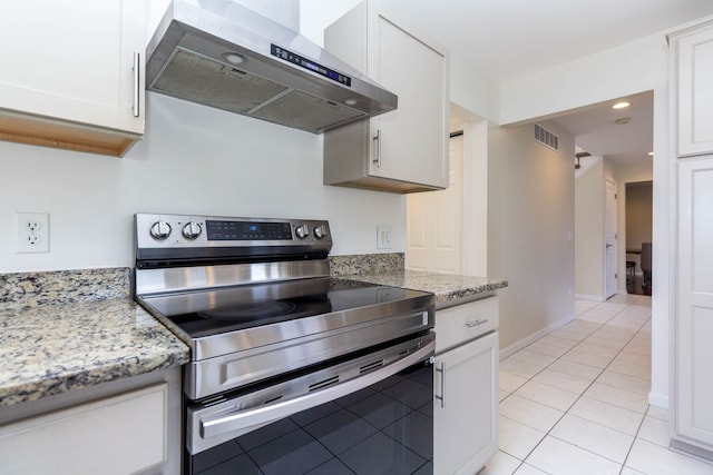 kitchen with stainless steel range with electric stovetop, under cabinet range hood, light tile patterned flooring, white cabinetry, and recessed lighting