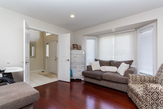 living area featuring healthy amount of natural light, wood finished floors, and recessed lighting