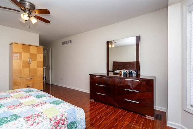 bedroom with dark wood-type flooring, baseboards, and a ceiling fan