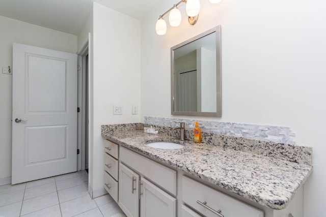 bathroom featuring tile patterned flooring and vanity