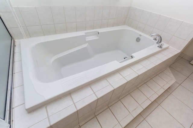 full bathroom with tile patterned floors and a bath