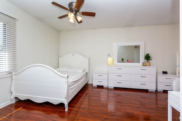 bedroom featuring wood finished floors, ceiling fan, and baseboards