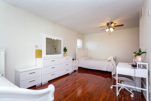 bedroom with dark wood finished floors, a desk, and a ceiling fan