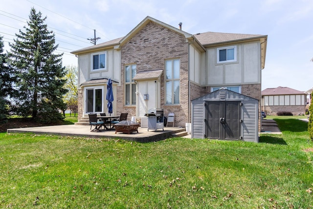 rear view of house featuring a storage shed, a patio, brick siding, a lawn, and an outdoor structure