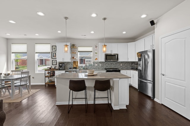 4051 Colfax Ct, Canton, MI 48188 - kitchen featuring appliances with stainless steel finishes, open shelves, a center island, decorative backsplash, and recessed lighting