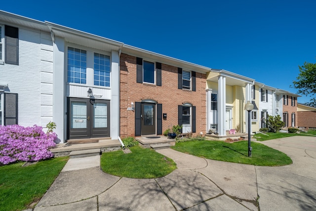 37475 Charter Oaks Blvd, Clinton Township, MI 48036 - townhome / multi-family property featuring brick siding, french doors, and a front lawn