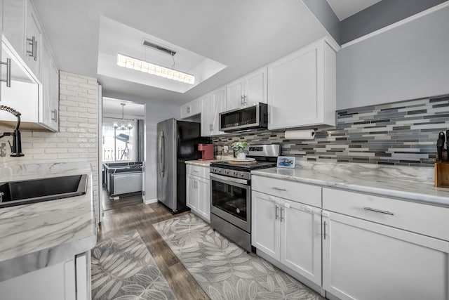 37475 Charter Oaks Blvd, Clinton Township, MI 48036 - kitchen with stainless steel appliances, wood finished floors, and decorative backsplash