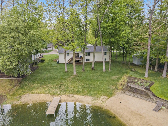 4754 Oaklane Dr, Hudsonville, MI 49426 - view of green lawn with a boat dock, a water view, and view of wooded area