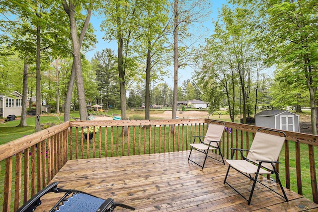 4754 Oaklane Dr, Hudsonville, MI 49426 - wooden terrace with a storage shed, an outbuilding, a yard, and view of wooded area
