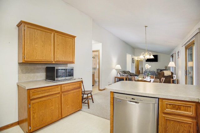 4754 Oaklane Dr, Hudsonville, MI 49426 - kitchen featuring stainless steel appliances, a chandelier, light countertops, open floor plan, and lofted ceiling