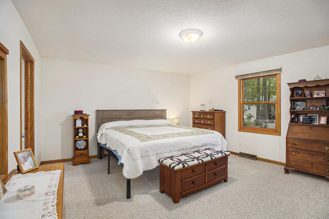 4754 Oaklane Dr, Hudsonville, MI 49426 - bedroom with baseboards, light carpet, and a textured ceiling
