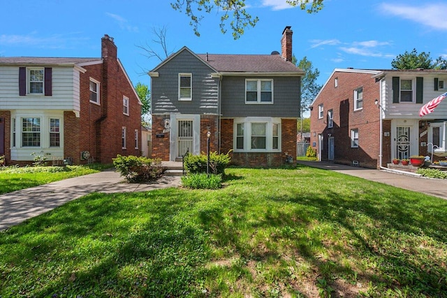 5921 Hillcrest St, Grosse Pointe, MI 48236 - colonial house featuring a front yard, brick siding, and a chimney