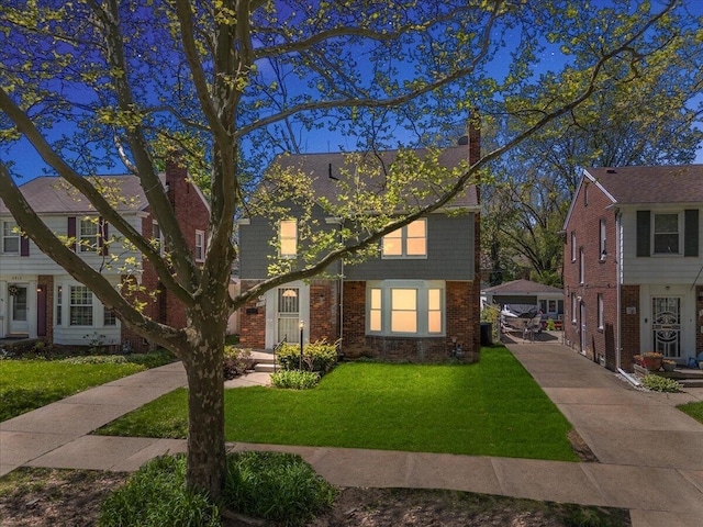 5921 Hillcrest St, Grosse Pointe, MI 48236 - view of front of property with a chimney, a front lawn, and brick siding
