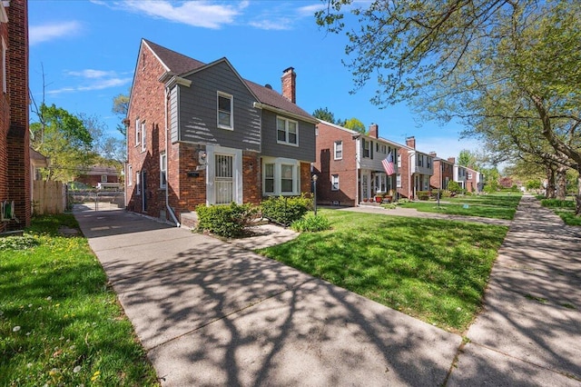 5921 Hillcrest St, Grosse Pointe, MI 48236 - view of front of house featuring brick siding, a gate, a residential view, and a chimney