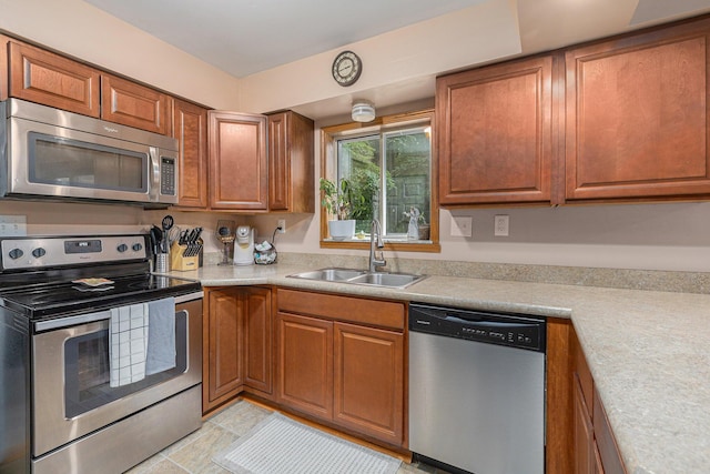 13195 Rainbow Dr, Gregory, MI 48137 - kitchen featuring appliances with stainless steel finishes, a sink, brown cabinets, and light countertops