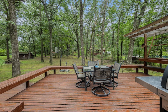 13195 Rainbow Dr, Gregory, MI 48137 - deck with outdoor dining area, a yard, an outdoor structure, and a shed