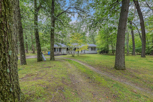13195 Rainbow Dr, Gregory, MI 48137 - view of front of house featuring driveway and a front lawn