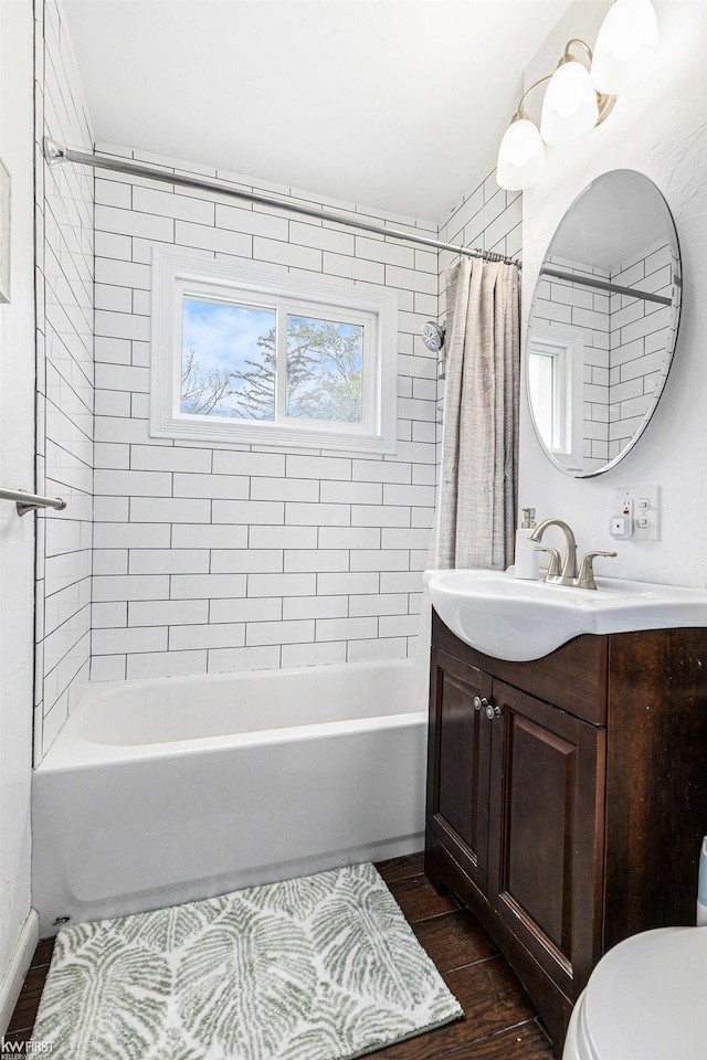 1566 Snyder Rd, East Lansing, MI 48823 - bathroom with shower / tub combo, toilet, vanity, and wood finished floors