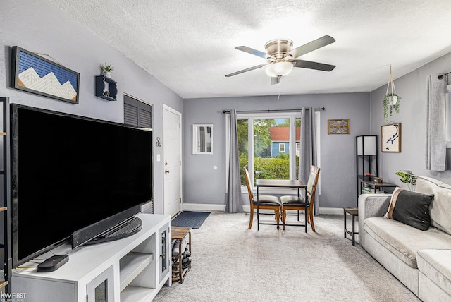 1566 Snyder Rd, East Lansing, MI 48823 - living room with baseboards, a ceiling fan, light carpet, and a textured ceiling