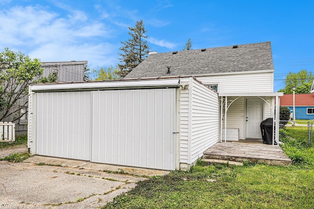 1566 Snyder Rd, East Lansing, MI 48823 - rear view of house featuring fence and a shingled roof
