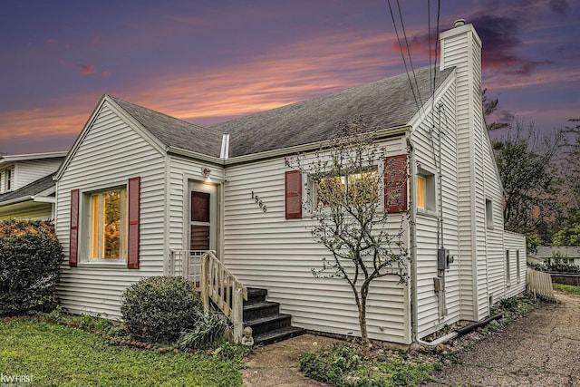 1566 Snyder Rd, East Lansing, MI 48823 - view of front of home with a chimney and a shingled roof