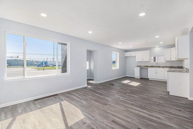 34641 Mound Rd, Sterling Heights, MI 48310 - kitchen featuring dark wood finished floors, baseboards, white cabinets, recessed lighting, and open floor plan