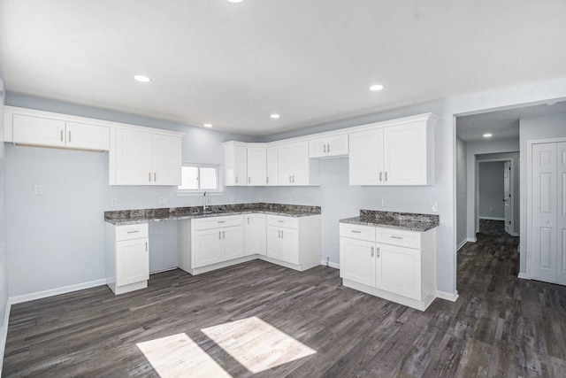 34641 Mound Rd, Sterling Heights, MI 48310 - kitchen with dark wood-type flooring, white cabinetry, dark stone countertops, baseboards, and recessed lighting