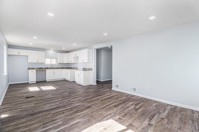 34641 Mound Rd, Sterling Heights, MI 48310 - kitchen with baseboards, dark wood-type flooring, white cabinets, recessed lighting, and open floor plan