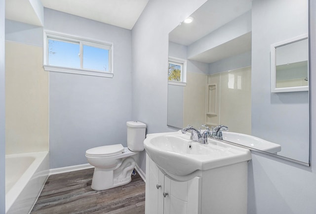 34641 Mound Rd, Sterling Heights, MI 48310 - full bathroom featuring toilet, wood finished floors, baseboards, and healthy amount of natural light