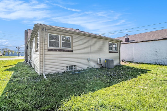 34641 Mound Rd, Sterling Heights, MI 48310 - view of side of home with central air condition unit and a lawn
