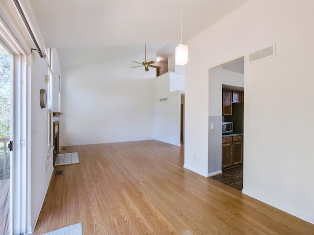 3201 Kilburn Park Cir, Ann Arbor, MI 48105 - unfurnished living room with light wood finished floors, ceiling fan, high vaulted ceiling, and baseboards