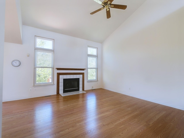 3201 Kilburn Park Cir, Ann Arbor, MI 48105 - unfurnished living room with high vaulted ceiling, wood finished floors, a fireplace, ceiling fan, and baseboards