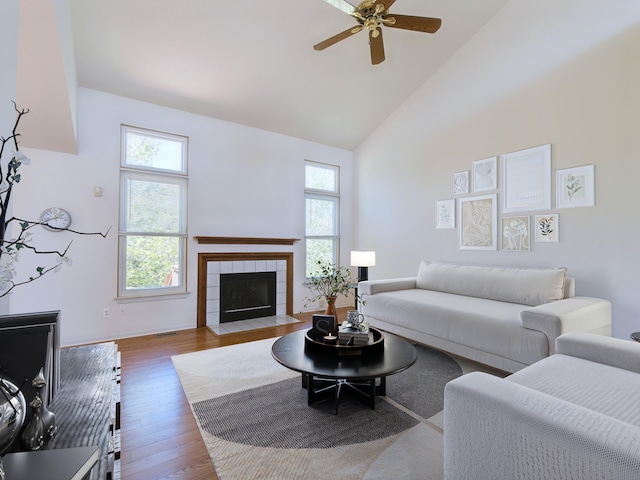 3201 Kilburn Park Cir, Ann Arbor, MI 48105 - living room with high vaulted ceiling, wood finished floors, ceiling fan, and a tile fireplace
