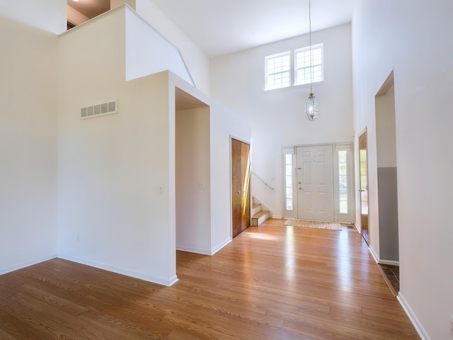 3201 Kilburn Park Cir, Ann Arbor, MI 48105 - entrance foyer featuring a high ceiling, stairway, wood finished floors, and baseboards