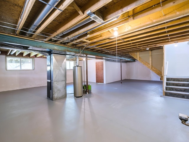 3201 Kilburn Park Cir, Ann Arbor, MI 48105 - below grade area featuring gas water heater, stairs, and heating unit