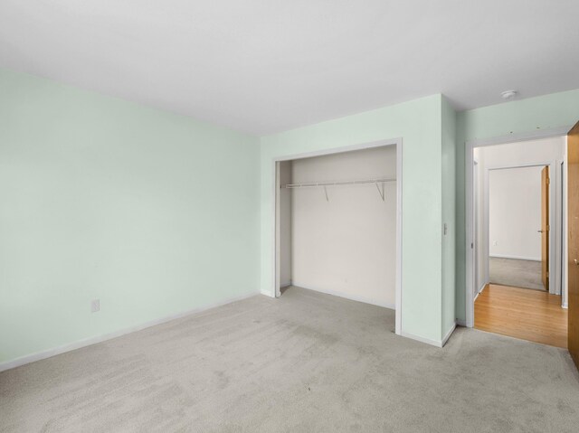 3201 Kilburn Park Cir, Ann Arbor, MI 48105 - unfurnished bedroom featuring carpet flooring, a closet, and baseboards