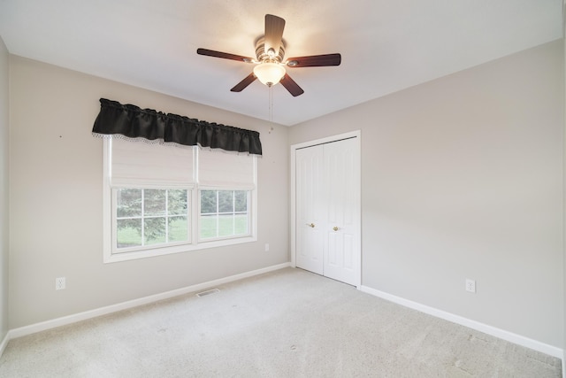 1972 Pine Ridge Dr, Manistee, MI 49660 - unfurnished bedroom with carpet, baseboards, a closet, and ceiling fan