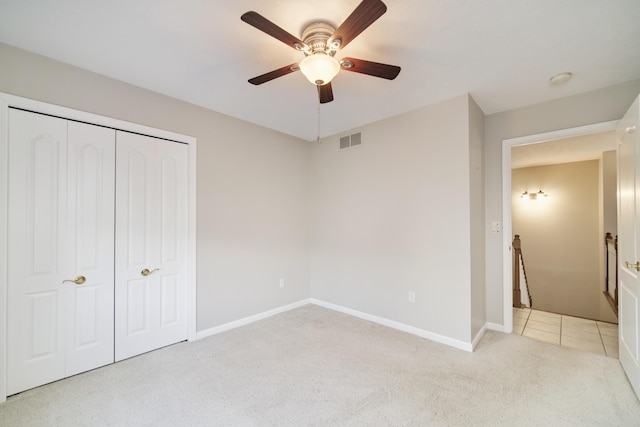 1972 Pine Ridge Dr, Manistee, MI 49660 - unfurnished bedroom with baseboards, a closet, carpet floors, and ceiling fan