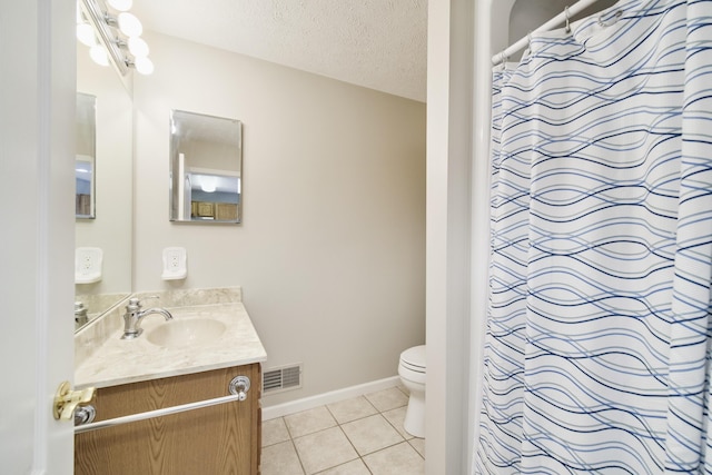 1972 Pine Ridge Dr, Manistee, MI 49660 - full bathroom with tile patterned floors, toilet, vanity, a textured ceiling, and baseboards