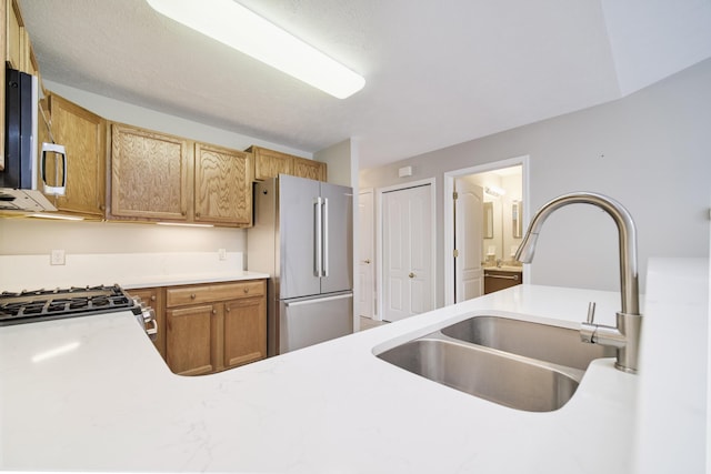 1972 Pine Ridge Dr, Manistee, MI 49660 - kitchen featuring appliances with stainless steel finishes, a sink, and light countertops